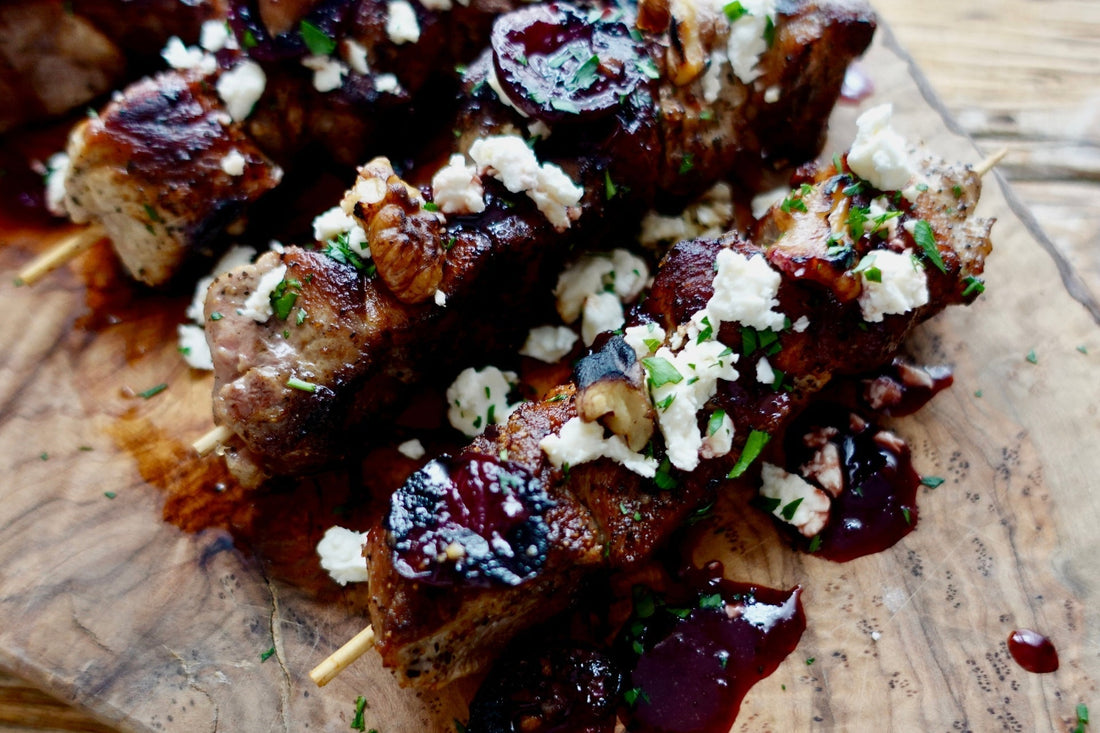 Grilled Ibérico Loin Roast skewers with fire-roasted cherry sauce, feta & walnuts