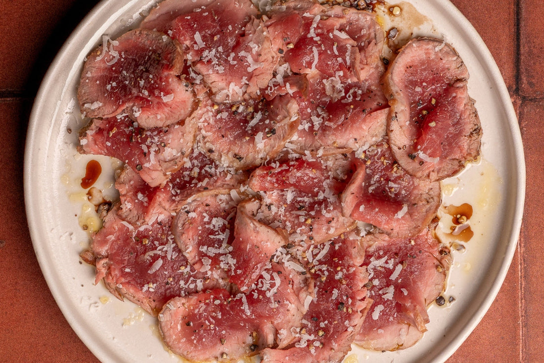 Easy grilled Ibérico Pork Tenderloin “carpaccio” with manchego cheese & basil oil