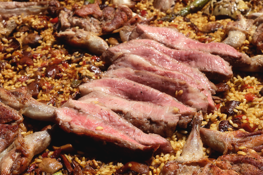 Spanish meat Paella with St. Louis Ribs, Abanico and Quail, & vegetables