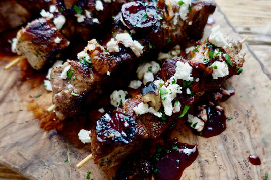 Grilled Ibérico Loin Roast skewers with fire-roasted cherry sauce, feta & walnuts