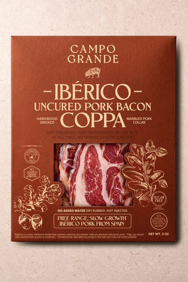 Sliced Ibérico coppa bacon package showing marbled red and white meat slices on russet-colored label.
