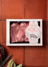 Campo Grande pork boneless Ibérico loin chops in white packaging displayed on red tile background.