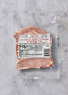 Hickory wood smoked uncured Iberico pork loin bacon package with label showing nutrition facts on gray surface.