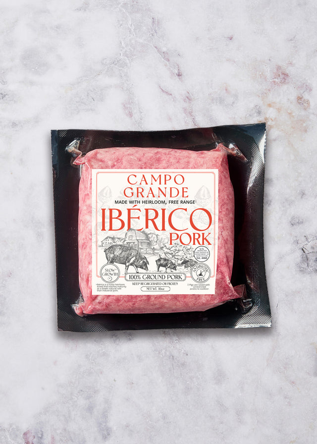 Campo Grande Iberico Pork ground pork package with red label on black tray against marble surface.