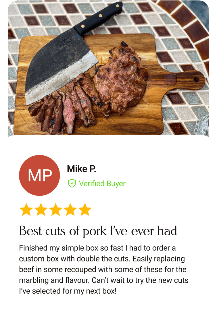Grilled Ibérico pork on a wooden cutting board
