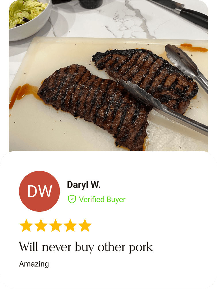 Char-grilled Ibérico pork steaks on a cutting board