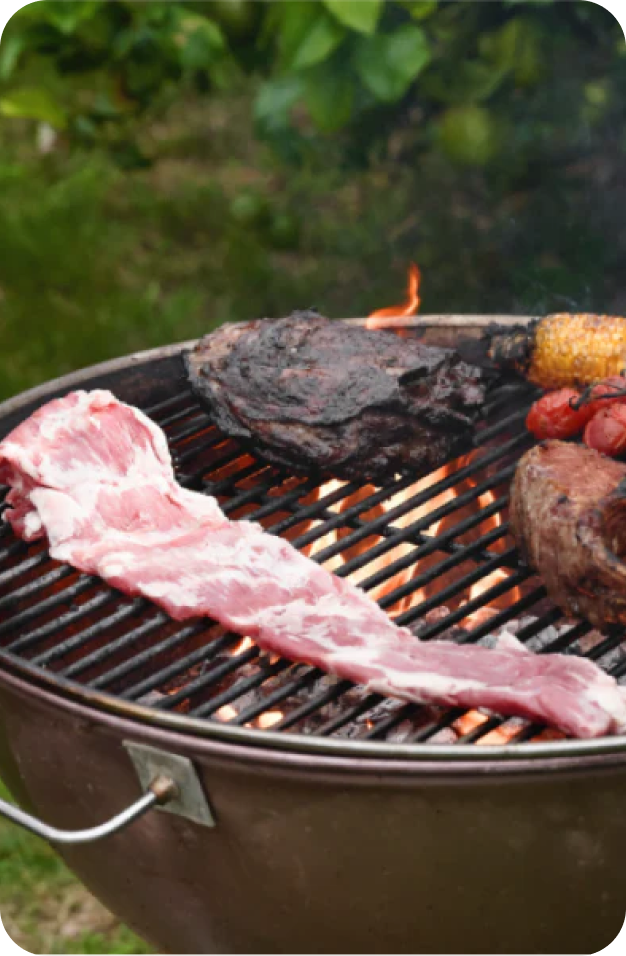 Ibérico pork cooking over a charcoal grill